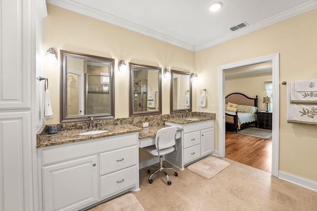 full bath with crown molding, visible vents, a sink, and double vanity