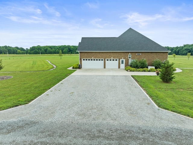 view of front of home with brick siding, gravel driveway, and a front yard