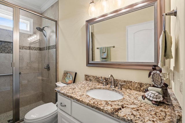 bathroom with toilet, a stall shower, ornamental molding, and vanity