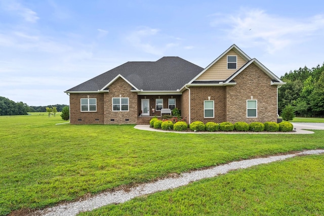 craftsman inspired home with roof with shingles, brick siding, crawl space, and a front yard