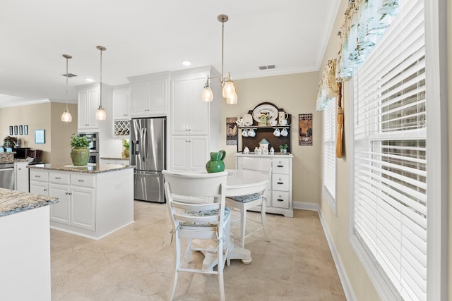 kitchen with white cabinets, visible vents, stainless steel appliances, and crown molding