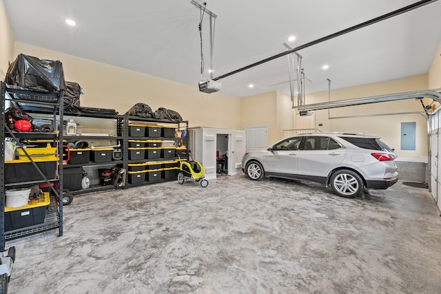 garage featuring electric panel and a garage door opener