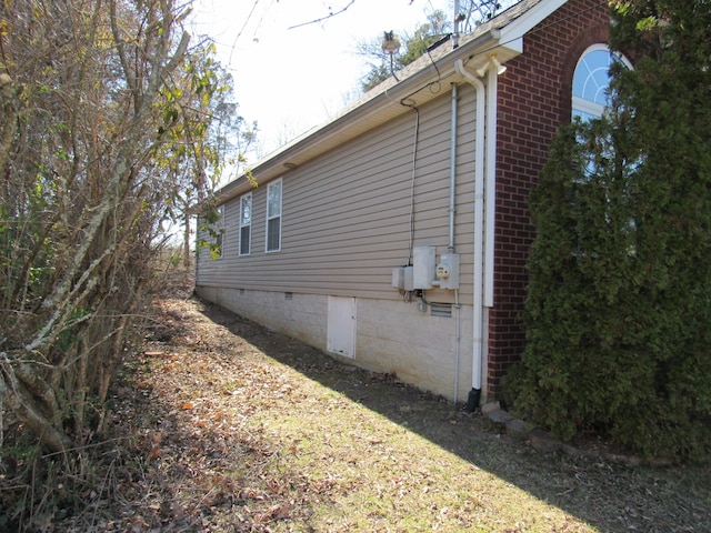 view of home's exterior featuring crawl space and brick siding