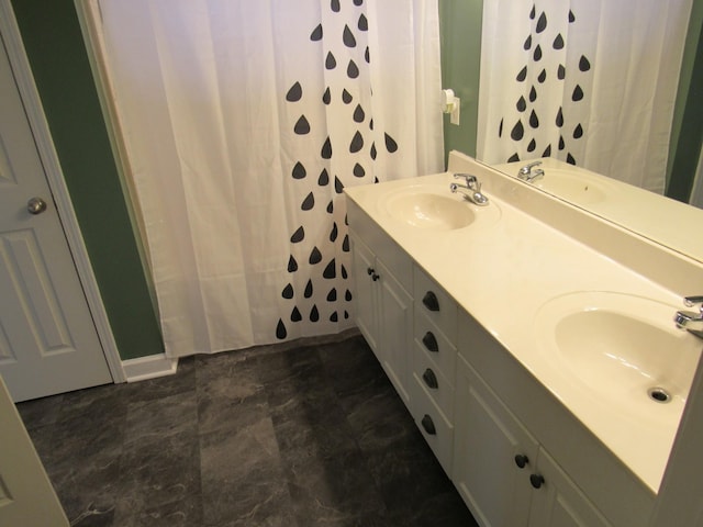 bathroom with a sink and double vanity