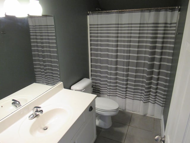 bathroom with toilet, a shower with curtain, tile patterned flooring, and vanity