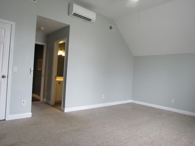 bonus room with light colored carpet, visible vents, vaulted ceiling, a wall mounted air conditioner, and baseboards