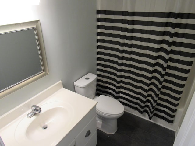 bathroom featuring toilet, tile patterned flooring, vanity, and a shower with shower curtain