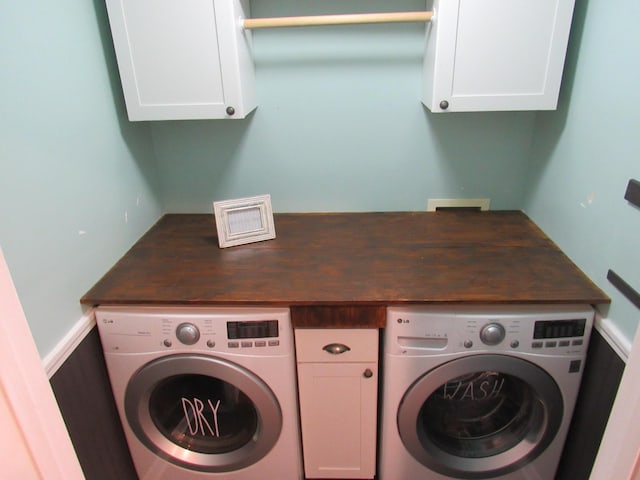 washroom featuring cabinet space and washer / clothes dryer