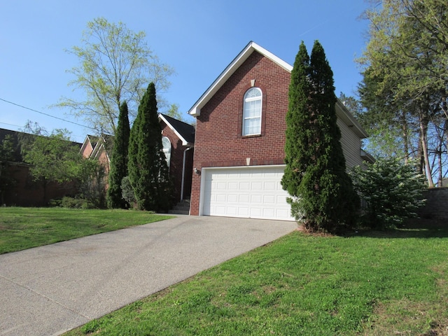 view of home's exterior featuring a yard, a garage, driveway, and brick siding