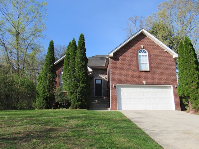 traditional home with an attached garage, driveway, a front yard, and brick siding