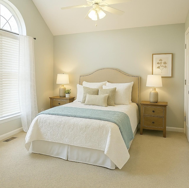 bedroom with carpet, visible vents, baseboards, and vaulted ceiling