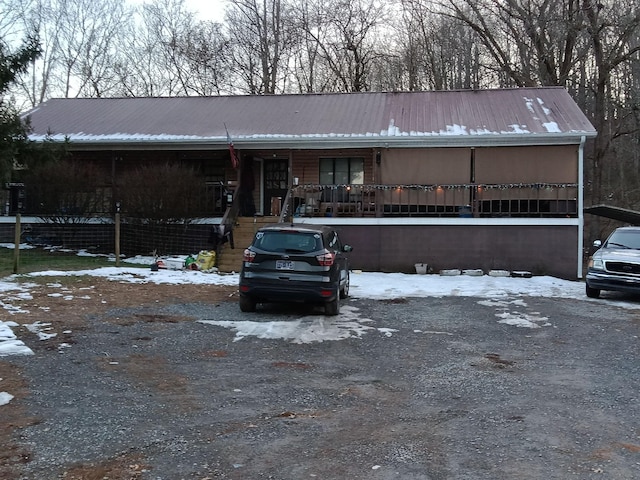 view of front facade with metal roof and a porch