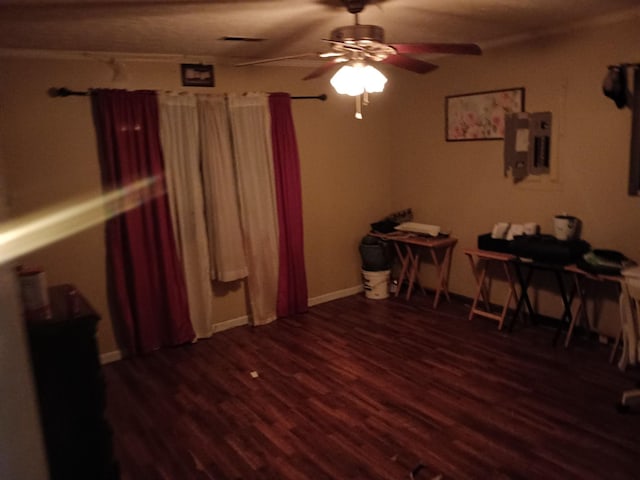 interior space with ceiling fan, visible vents, wood finished floors, and electric panel