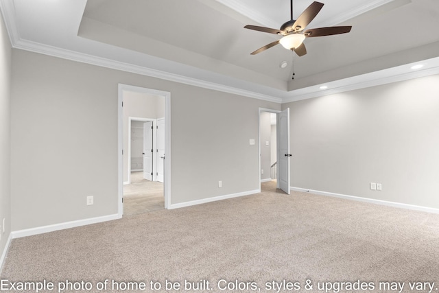 carpeted empty room featuring baseboards, a raised ceiling, and crown molding