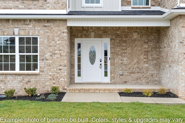 view of exterior entry featuring brick siding and board and batten siding