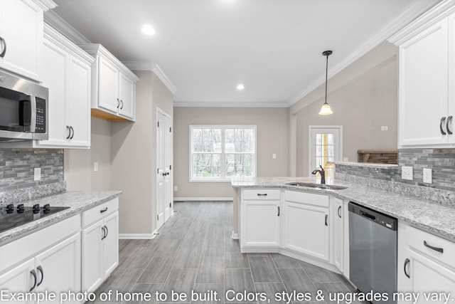 kitchen with stainless steel appliances, a peninsula, a sink, and white cabinets