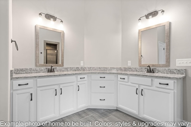 bathroom featuring double vanity, wood tiled floor, and a sink