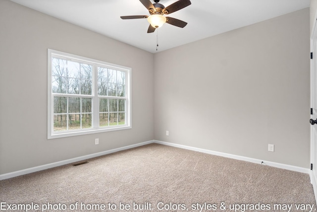 carpeted empty room featuring baseboards, visible vents, and a ceiling fan