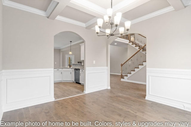 unfurnished dining area featuring arched walkways, coffered ceiling, light wood-style floors, stairs, and beam ceiling