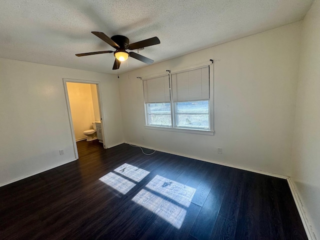 unfurnished bedroom featuring a textured ceiling, a ceiling fan, dark wood-style flooring, and ensuite bathroom