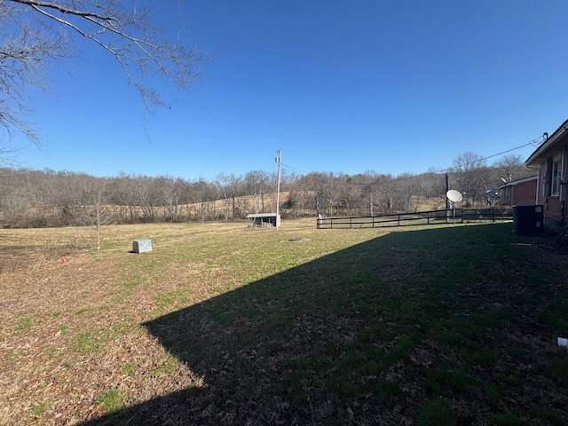 view of yard with cooling unit and fence