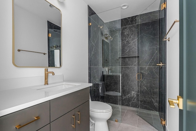 full bathroom with toilet, tile patterned floors, a marble finish shower, and vanity