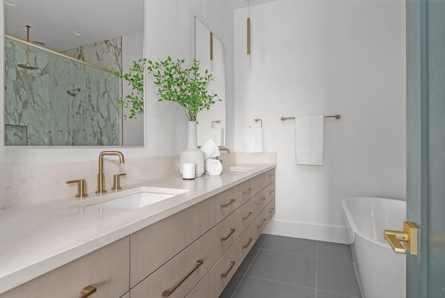 full bathroom featuring double vanity, a marble finish shower, tile patterned flooring, a freestanding bath, and a sink