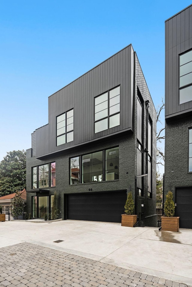 contemporary home featuring a garage and concrete driveway