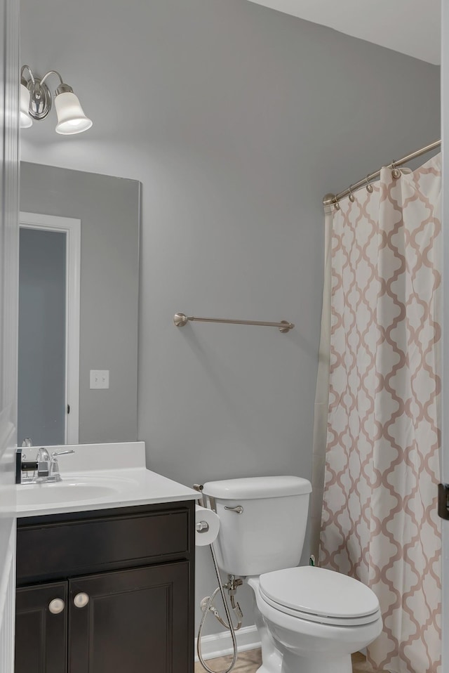 full bath featuring a shower with shower curtain, vanity, and toilet