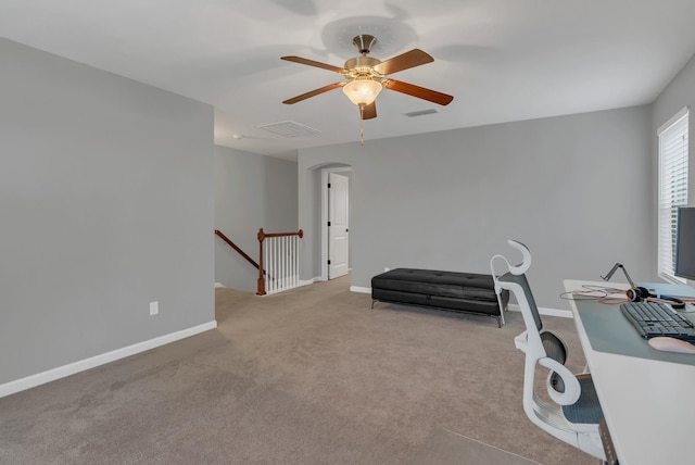 interior space with carpet flooring, baseboards, visible vents, and an upstairs landing