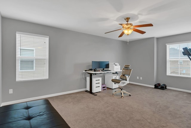 office space featuring a ceiling fan, carpet flooring, and baseboards