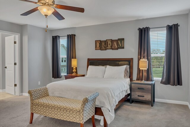 bedroom featuring ceiling fan, baseboards, and carpet flooring