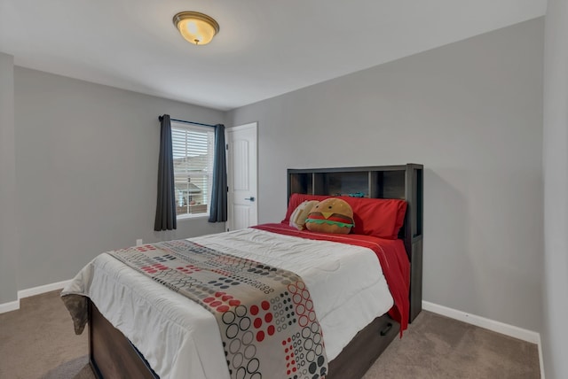 carpeted bedroom featuring baseboards