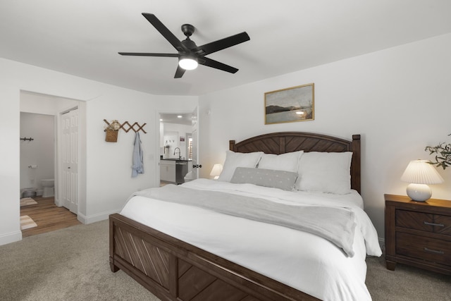 bedroom with a ceiling fan, carpet, baseboards, and ensuite bathroom