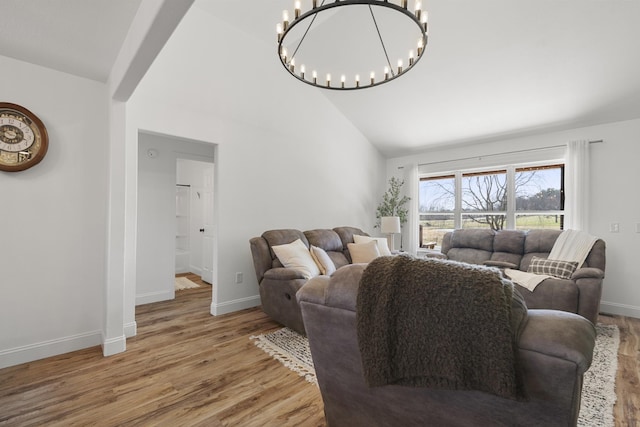 living room featuring high vaulted ceiling, baseboards, and wood finished floors