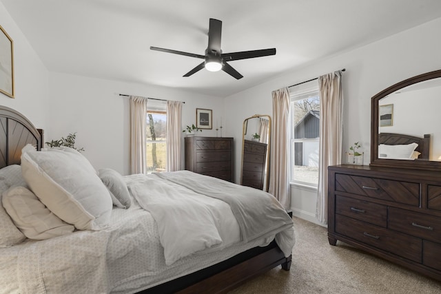 bedroom with baseboards, a ceiling fan, and light colored carpet