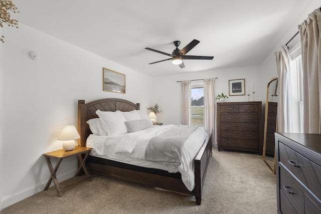 bedroom featuring a ceiling fan, access to exterior, light colored carpet, and baseboards