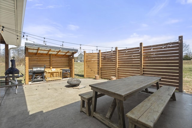 view of patio featuring grilling area, a fire pit, and outdoor dining area