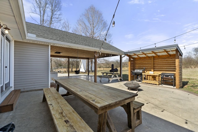 view of patio with a grill and a fire pit