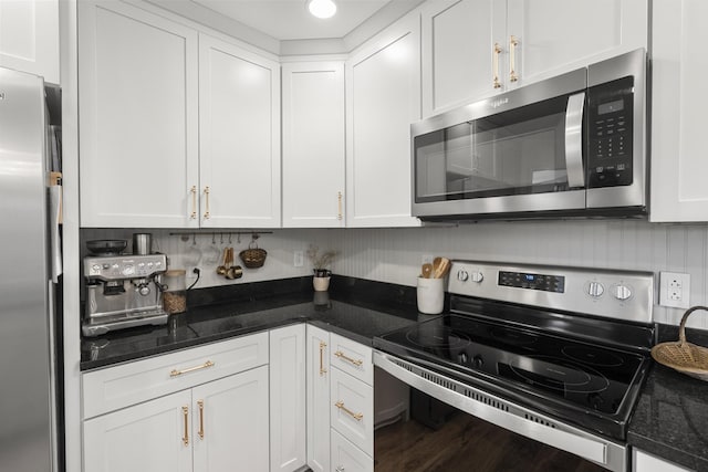 kitchen with tasteful backsplash, appliances with stainless steel finishes, and white cabinets