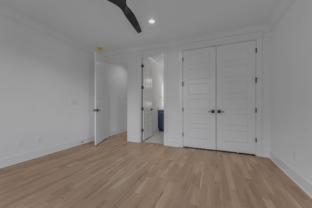 unfurnished bedroom featuring light wood finished floors, baseboards, a ceiling fan, ensuite bathroom, and a closet