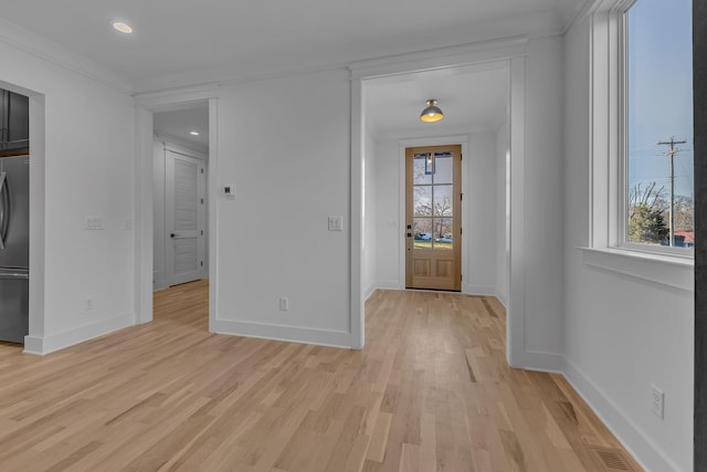 entrance foyer featuring recessed lighting, light wood-style flooring, and baseboards