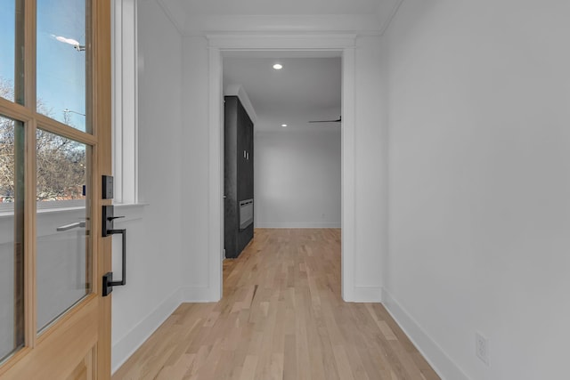 hall with light wood-style flooring, baseboards, crown molding, and recessed lighting