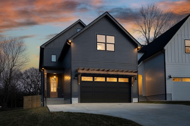 view of front of home with driveway, an attached garage, and board and batten siding