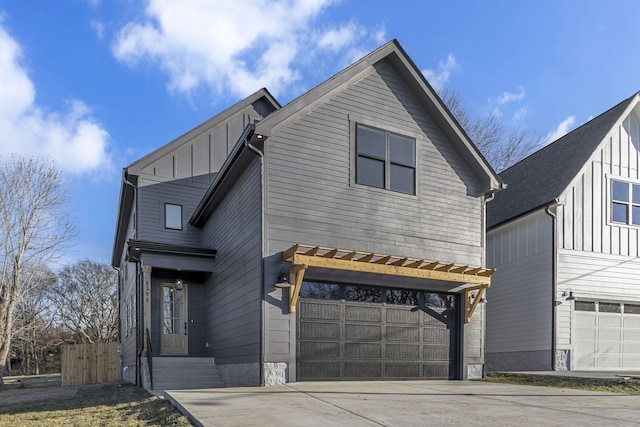 view of front of property with an attached garage, board and batten siding, and concrete driveway