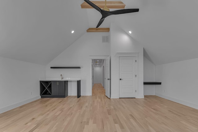 additional living space with vaulted ceiling, light wood-type flooring, visible vents, and baseboards