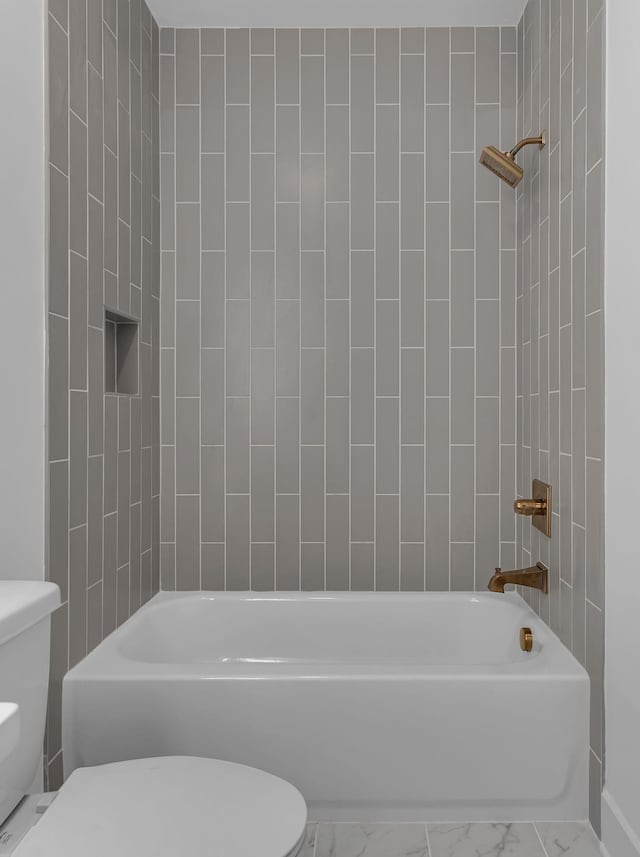 full bath featuring shower / washtub combination, marble finish floor, and toilet