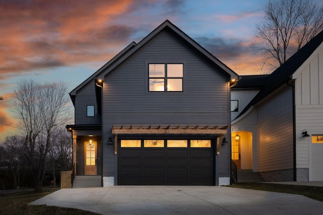 view of front facade with a garage, driveway, and board and batten siding