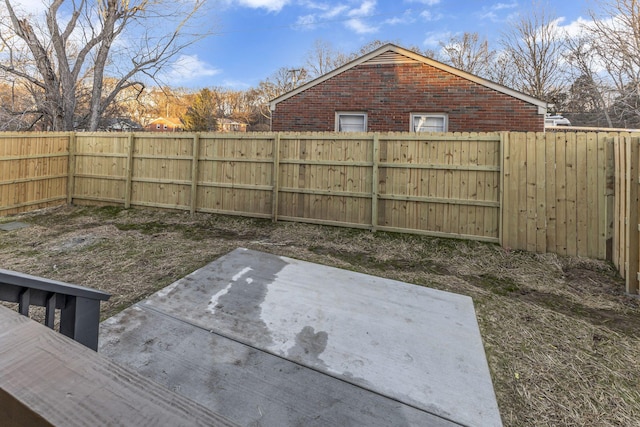 view of yard featuring a patio area and a fenced backyard