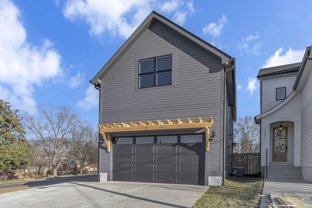 view of side of property with a garage and driveway